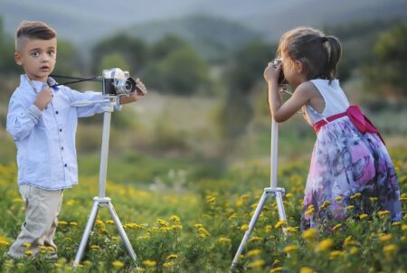 This is an image of kids use cameras outdoors