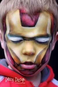 kid with his face painted like the iron man
