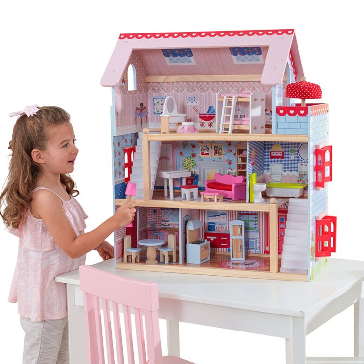 girl playing with a dollhouse 