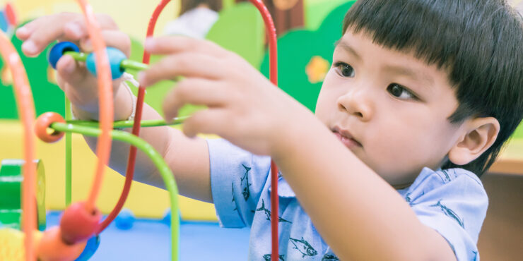 kid playing with educational toy