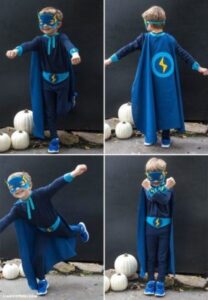 little boy dressed up in a superhero outfit