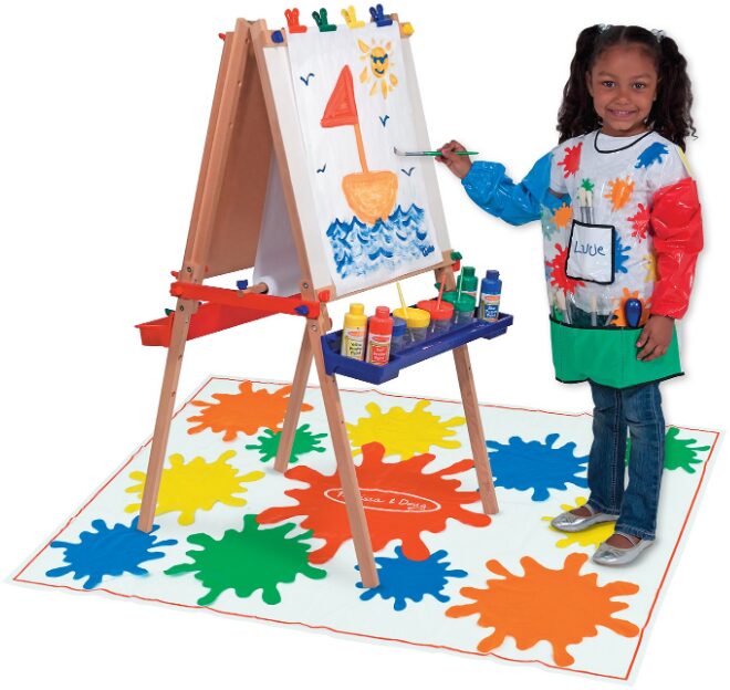 this is an image of a girl standing and painting on an easel board