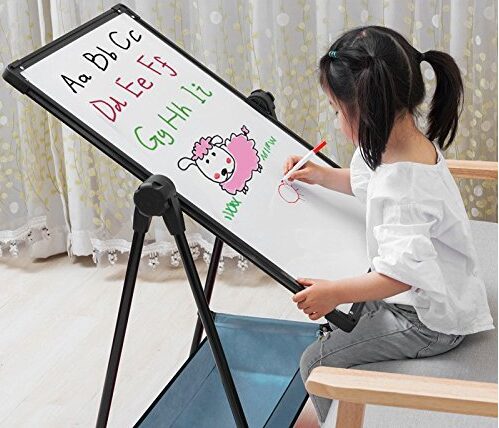 this is an image of a girl sitting and drawing on an art easel
