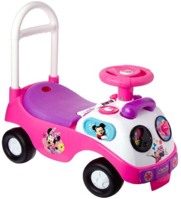 This is an image of toddler's ride on car with minnie mouse design in pink, white and purple colors