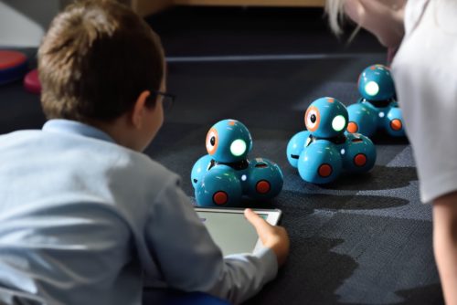 Boy playing on the ipad controlling a STEM toy