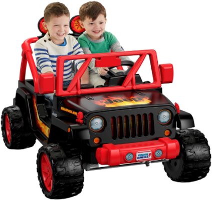 This is an image of Toddler in a 12v red jeep wrangler 