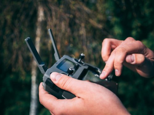 this is an image of a remote control boat controller operated with a pair of hands