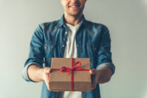 this is an image of a man holding a gift box