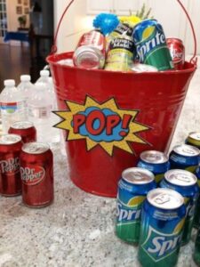 superhero logo on bucket with drinks inside