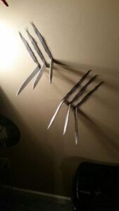 wolverine claw stick out from a wall with claw marks